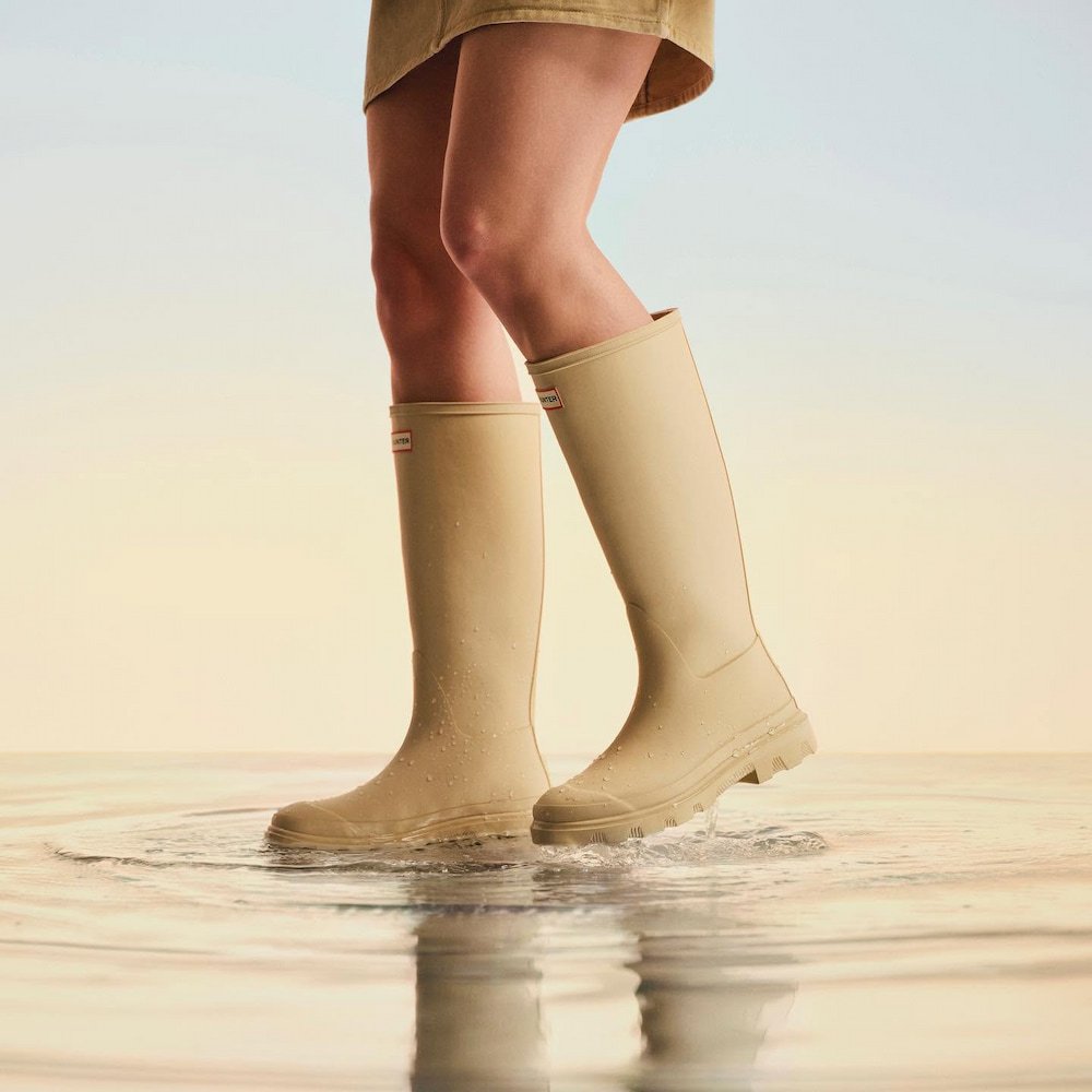 模特兒身穿 HUNTER 奶茶色高筒雨靴