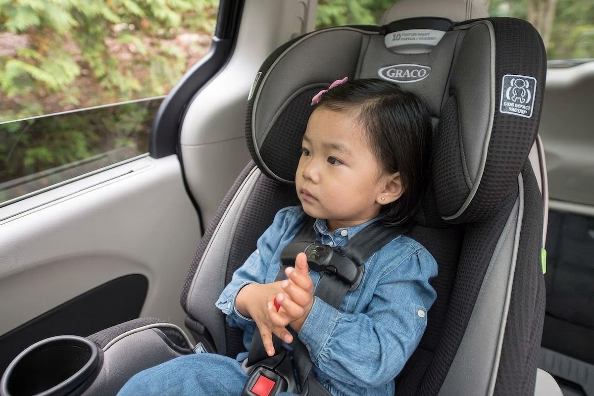 坐在汽車安全座椅上、需提防車內溫度過熱的女童。